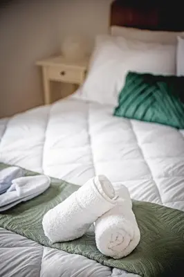 a white sock sitting on top of a bed at Althaea Mare in Lofou