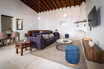 a living room with a couch and a table at Althaea Mare in Lofou