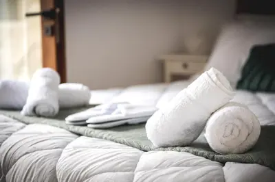 a bed with white socks and towels on it at Althaea Mare in Lofou