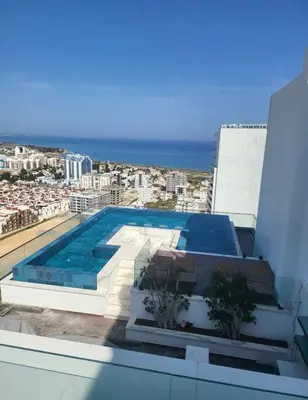 a swimming pool on the roof of a building at Grand Sapphire Resort in Aglantzia