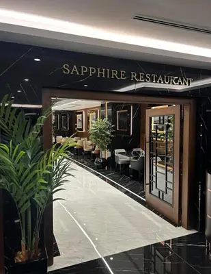 a entrance to a restaurant with tables and chairs at Grand Sapphire Resort in Aglantzia