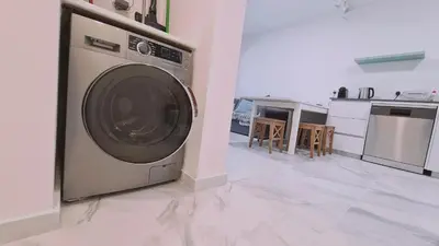 a kitchen with a washing machine in a room at STAY The Getaway Apartment in Pyla
