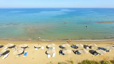 a group of umbrellas and chairs on a beach at Cheap Holiday Opportunity in North Cyprus in Larnaka