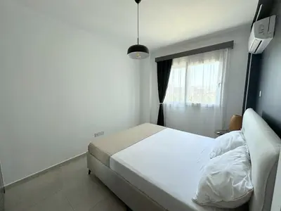 a bedroom with a white bed and a window at Cheap Holiday Opportunity in North Cyprus in Larnaka