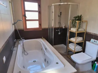 a bathroom with a tub and a toilet at Ambelli Villa 4 Bedroom Luxury Villa in Skarinou