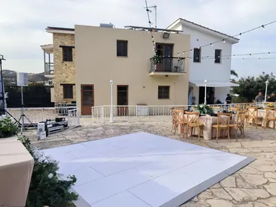 a patio with a table and chairs in front of a building at Ambelli Villa 4 Bedroom Luxury Villa in Skarinou