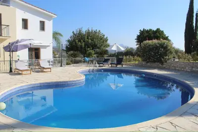 a large blue swimming pool next to a house at Ambelli Villa 4 Bedroom Luxury Villa in Skarinou