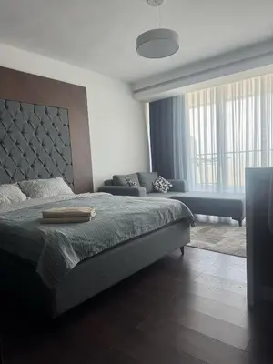a bedroom with a large bed and a couch at Grand Saphire Resort Apartment-I in İskele