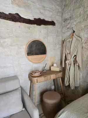 a bedroom with a dressing table and a bed at Xenonas Hiliostrofi in Anoyira