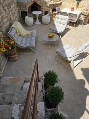 a patio with white furniture and a table and chairs at Xenonas Hiliostrofi in Anoyira