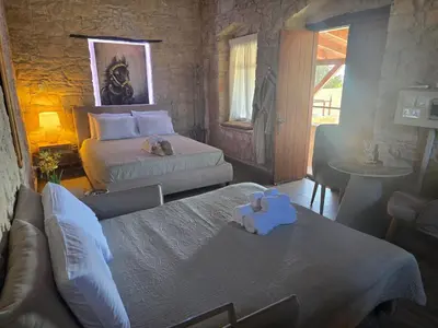 a bedroom with two beds with towels on them at Xenonas Hiliostrofi in Anoyira
