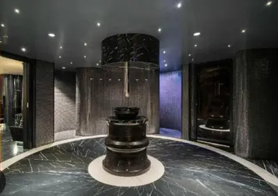 a lobby with a table with a vase on it at Grand Sapphire Resort in Aglantzia
