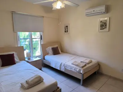a bedroom with two beds and a window at 2 Bed Apartment in Kiti with Communal Pool in Kiti