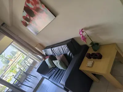 a living room with a black couch and a table at 2 Bed Apartment in Kiti with Communal Pool in Kiti