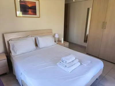 a bedroom with a white bed with towels on it at 2 Bed Apartment in Kiti with Communal Pool in Kiti