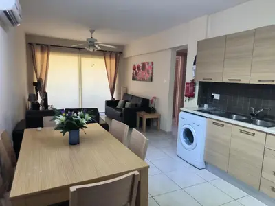 a kitchen and living room with a table and a dining room at 2 Bed Apartment in Kiti with Communal Pool in Kiti