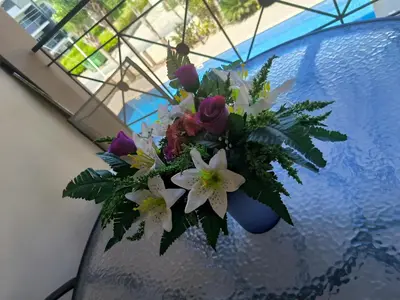 a bouquet of flowers in a blue vase on a table at 2 Bed Apartment in Kiti with Communal Pool in Kiti