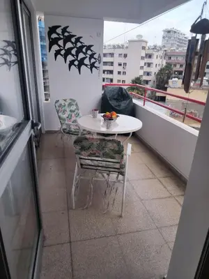 a white table and chairs on a balcony with a table at 3 Bedroom Apartment Old Town Larnaca 5 minute walk to Finnikoudes Beach in Larnaka
