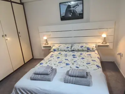 a bedroom with a bed with two towels on it at 3 Bedroom Apartment Old Town Larnaca 5 minute walk to Finnikoudes Beach in Larnaka