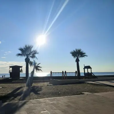 a playground on the beach with palm trees at 2 Bedroom Brand New Apartment Mc Kenzie 2 minute to the Mc Kenzie Beach in Larnaka