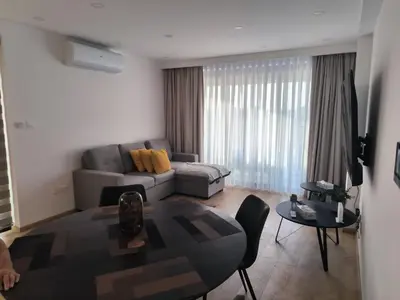 a living room with a couch and a table at 2 Bedroom Brand New Apartment Mc Kenzie 2 minute to the Mc Kenzie Beach in Larnaka