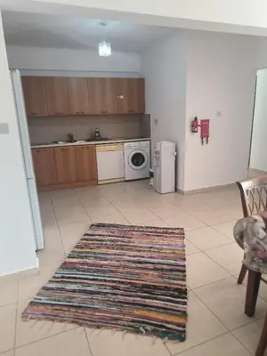 a kitchen with a rug on the floor at 3 Bedroom Affordable Apartment in Oroklini with Communal Pool in Voroklini