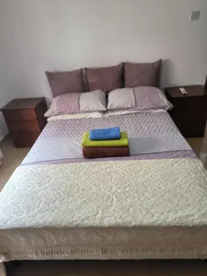a bed with two towels sitting on top of it at 3 Bedroom Affordable Apartment in Oroklini with Communal Pool in Voroklini