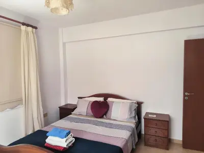 a bedroom with a bed with towels on it at 3 Bedroom Affordable Apartment in Oroklini with Communal Pool in Voroklini