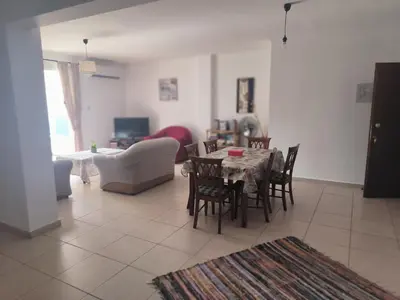 a living room with a table and chairs at 3 Bedroom Affordable Apartment in Oroklini with Communal Pool in Voroklini