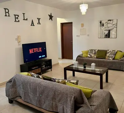 a living room with two couches and a tv at 2 Bedroom Penthouse Apartment in Oroklini with Communal Pool in Voroklini