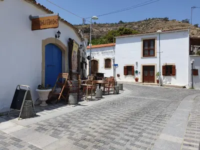 a cobblestone street in a town with white buildings at 2 Bedroom Penthouse Apartment in Oroklini with Communal Pool in Voroklini