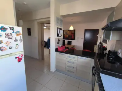 a kitchen with a refrigerator with magnets on it at Superior 1 bed apartment in Oroklini with Communal Pool in Voroklini