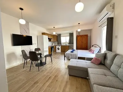 a living room with a couch and a bed at Adonis Holiday Apt - Nicosia in Nicosia