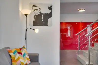 a living room with a couch and a red wall at Makenzy Star 2bd duplex 300m from beach in Larnaka
