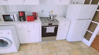 a kitchen with a stove and a washing machine at STAY Virtuoso Apartment in Nicosia