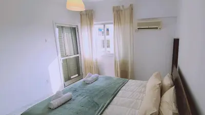 a bedroom with a bed with pillows and a window at STAY Virtuoso Apartment in Nicosia
