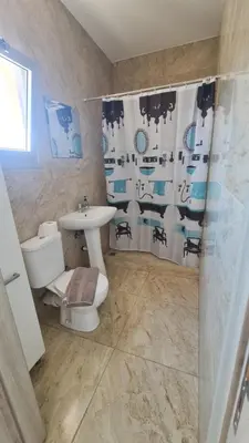 a bathroom with a sink and a toilet and a shower at RIVERA Studios 1 in Limassol