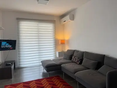 a living room with a couch and a television at The Comfort Stay in Nicosia Verenikis - Platform 357 in Nicosia