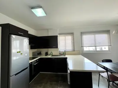 a kitchen with a white refrigerator and a table at The Comfort Stay in Nicosia Verenikis - Platform 357 in Nicosia