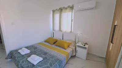 a small bedroom with a bed with towels on it at STAY Azure Dream Apartment in Paralimni