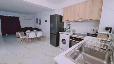 a kitchen with a sink and a stove and a dishwasher at STAY Azure Dream Apartment in Paralimni