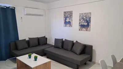 a living room with a couch and a table at STAY Azure Dream Apartment in Paralimni