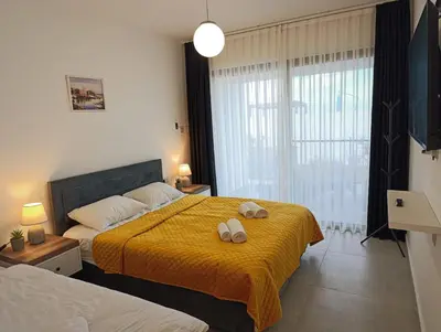 a bedroom with a bed with two towels on it at Family large apartment in Bahçeli in Aglantzia