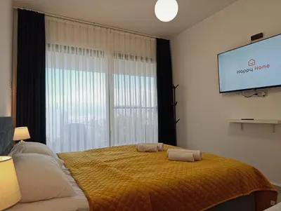 a bedroom with a bed and a flat screen tv at Family large apartment in Bahçeli in Aglantzia