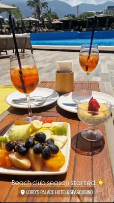 a table with two glasses and a plate of fruit at Family large apartment in Bahçeli in Aglantzia