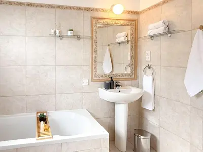 a bathroom with a sink and a bath tub and a sink at Sunny Villa with Hot Tub, Garden and 2 Bedrooms, 5 Minutes to the Beach in Pyla