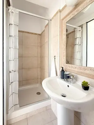 a white bathroom with a sink and a tub at Sunny Villa with Hot Tub, Garden and 2 Bedrooms, 5 Minutes to the Beach in Pyla