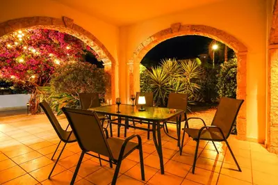 a dining room with a table and chairs at Sunny Villa with Hot Tub, Garden and 2 Bedrooms, 5 Minutes to the Beach in Pyla