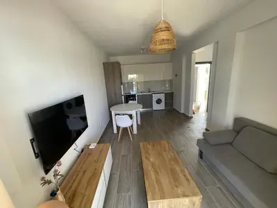 a living room with a couch and a table at Green Bay Cosy Escape in Protaras