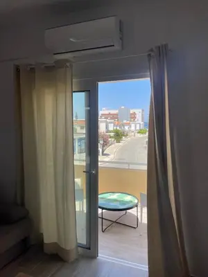 a sliding glass door with a view of a balcony at Green Bay Cosy Escape in Protaras